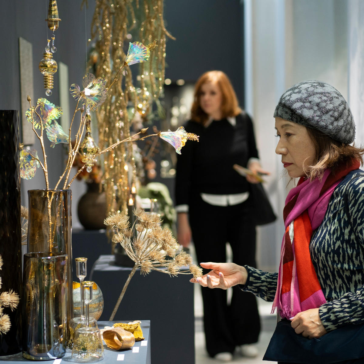 A woman looks at the Christmas window display at a trade fair.